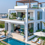Modern white luxury villa in Dubai with glass balcony and contemporary architecture